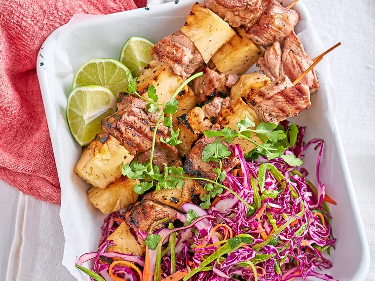 Pork and pineapple skewers with red cabbage salad