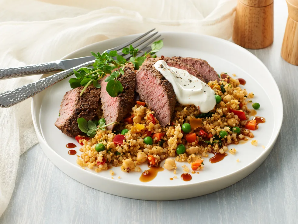 Pearl couscous with spiced lamb backstrap and pomegranate dressing