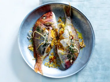 Tray-baked whole fish with citrus couscous stuffing