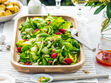 Green salad with shaved cucumber, peas, mint and raspberry dressing
