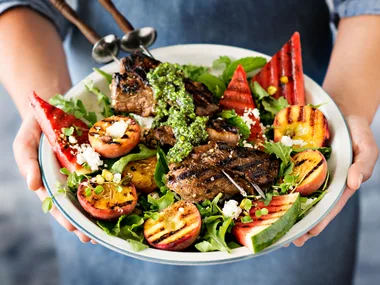 Barbecue lamb skewers with pistachio pesto and grilled fruit salad