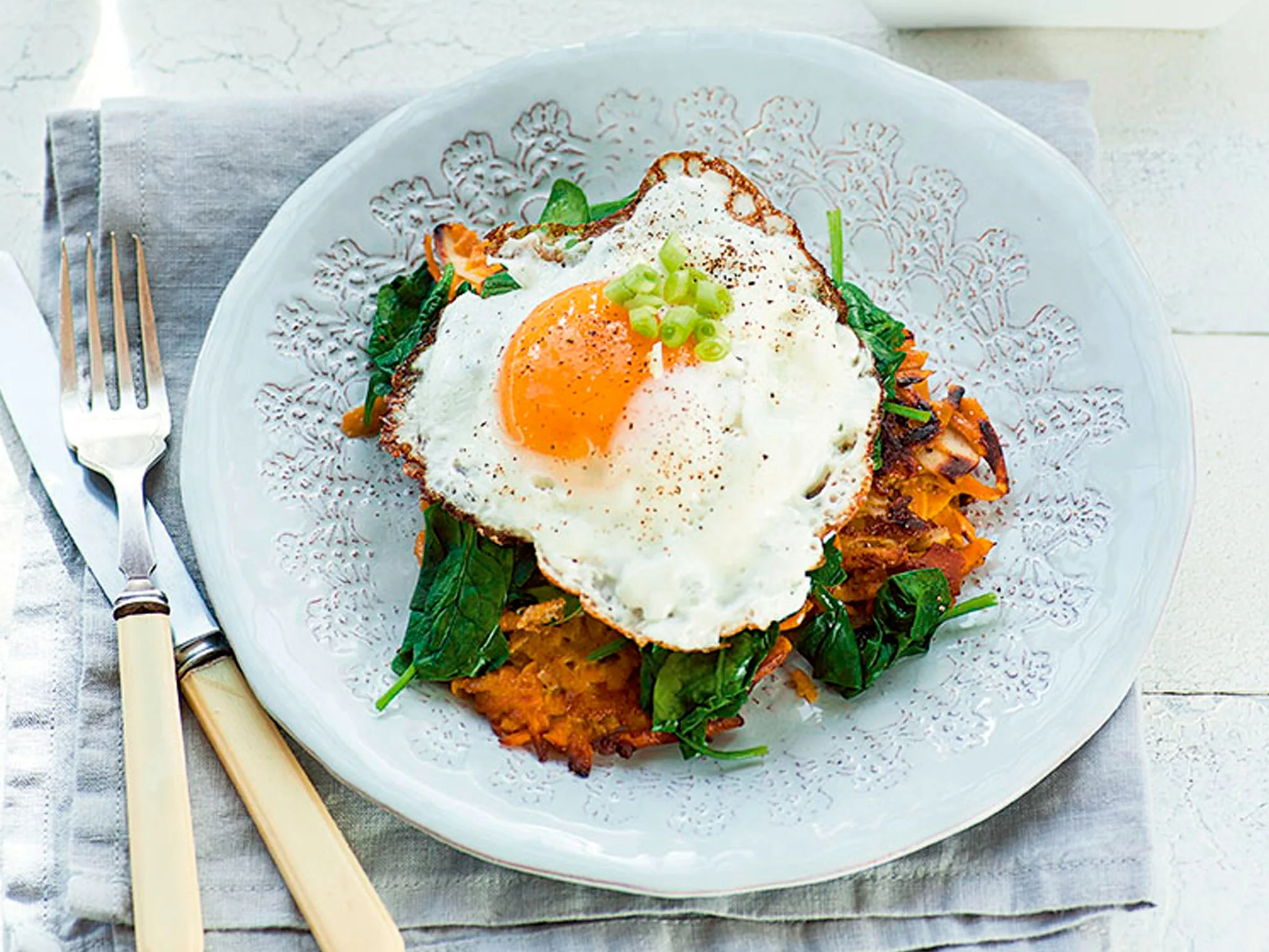 Kumara rosti with wilted greens and fried eggs