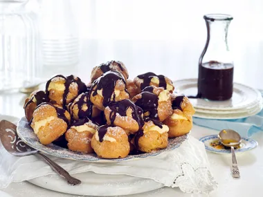 Profiteroles with passionfruit cream and chocolate fudge