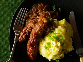 Champ with sausages and brown onion gravy