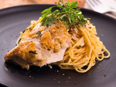 Chicken with bacon and thyme sauce on spaghetti