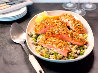 Orange and thyme-crusted salmon on broad beans and leeks