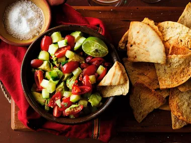 Pita chips with avocado and tomato salsa