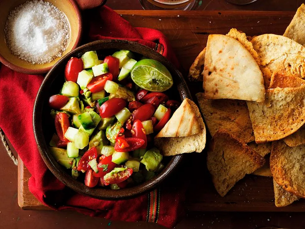 Pita chips with avocado and tomato salsa