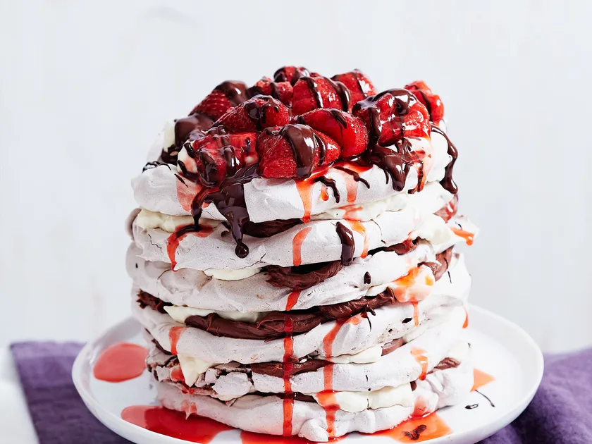 Layered chocolate meringue cake with strawberry compote