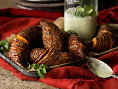 Hasselback kumara with green yoghurt sauce