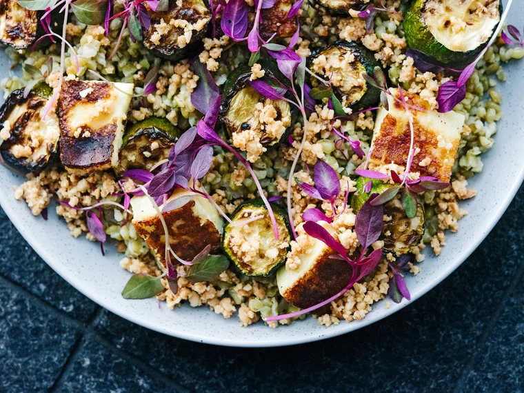 Warm salad of freekeh, roasted courgettes, macadamia and haloumi