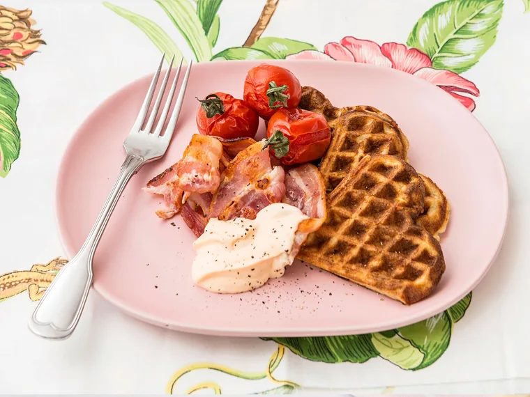 Potato and parmesan waffles with tomatoes, bacon and spicy mayo