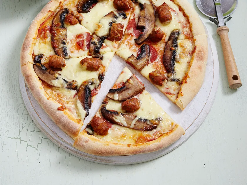 Italian sausage and pepperoni pizza with rocket salad