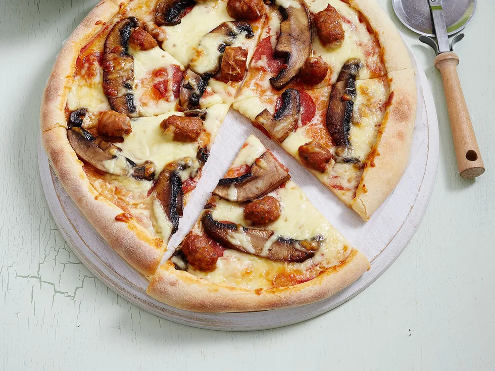 Italian sausage and pepperoni pizza with rocket salad