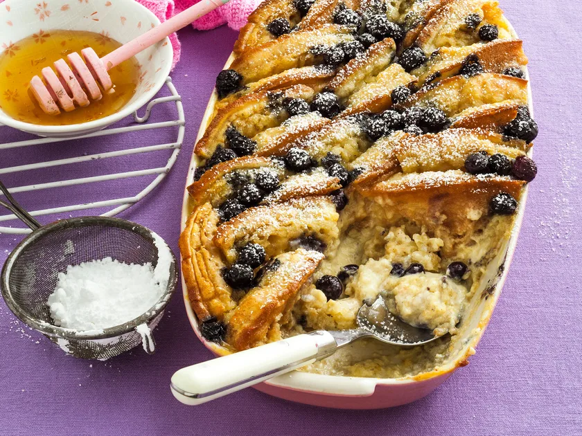 Baked crumpet bread and butter pudding with blueberries
