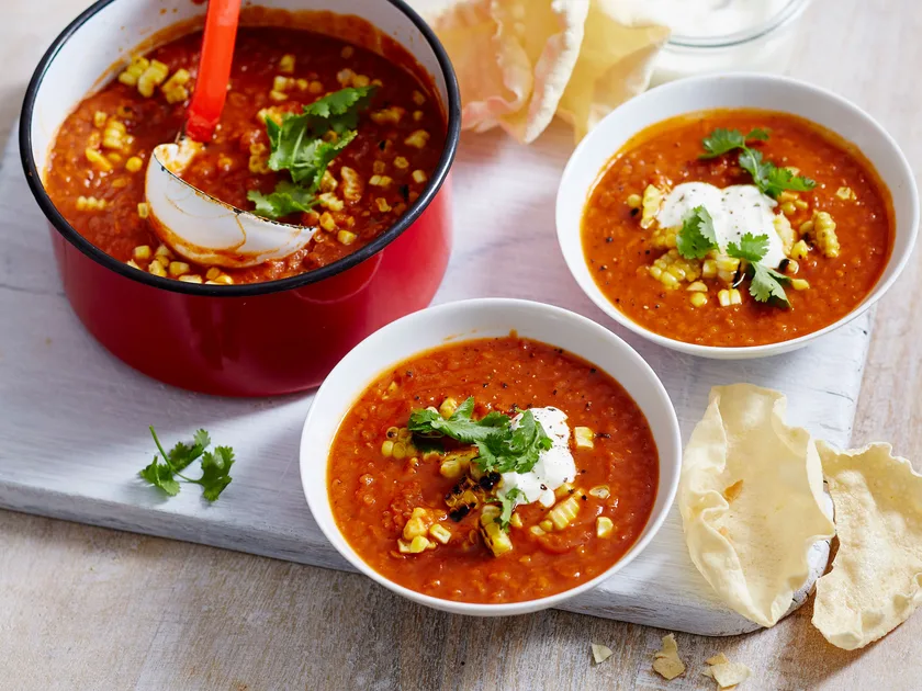 Spiced tomato and lentil soup with corn and coriander