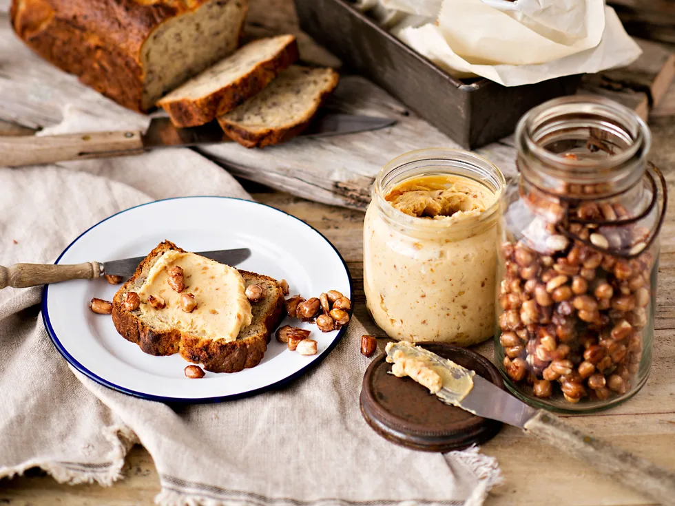 Banana bread with sweet nut butter and toasted peanuts