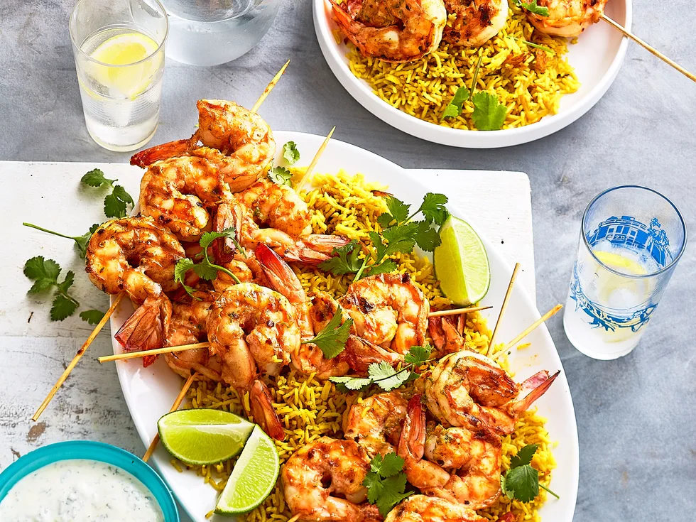 Spiced prawn skewers with coriander pilaf and lime yoghurt