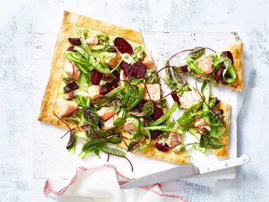 Salmon and beetroot tart with broad bean and pea topping