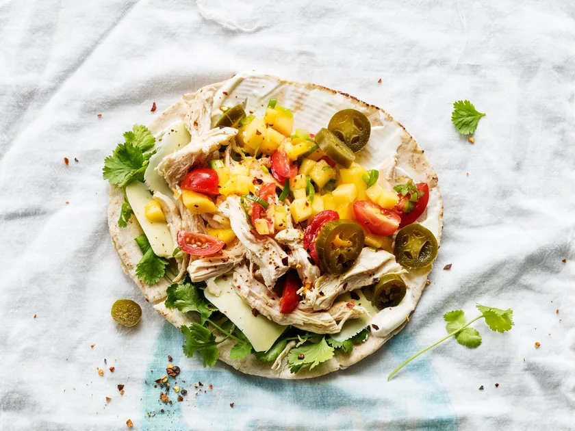 Pulled chicken and mango salsa topped pita bread tacos