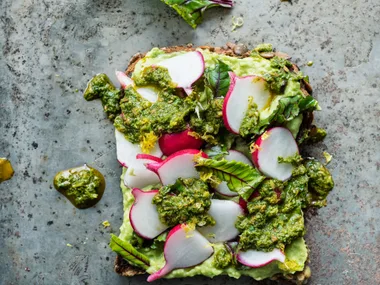Avocado cream, baby beet leaves and radish with chermoula on five-grain
