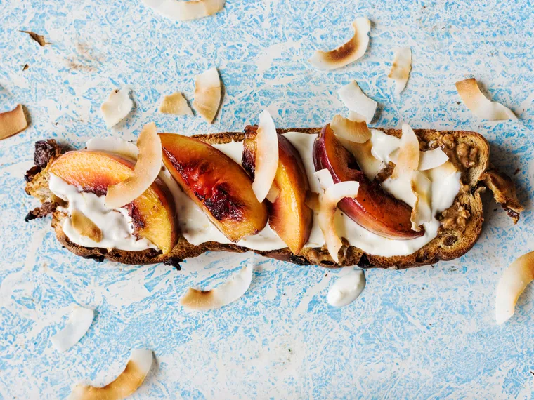 Fruit toast with almond butter, Greek yoghurt and seared peaches