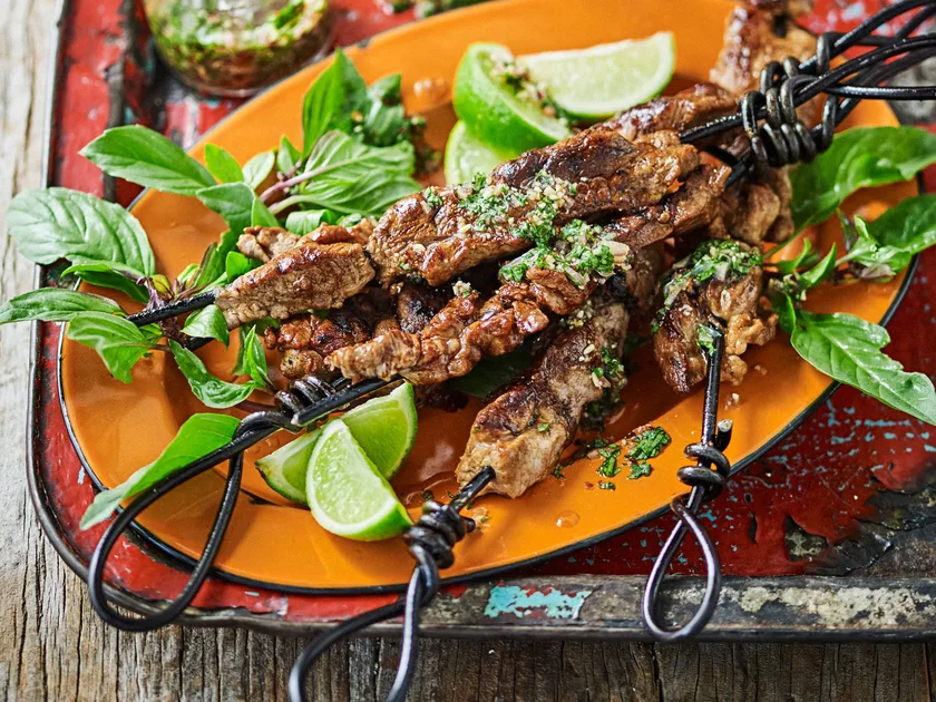 Grilled pork skewers with coriander and lime dipping sauce