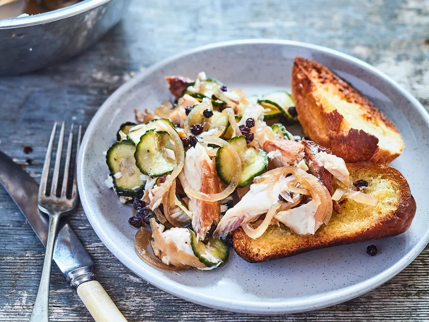 Bruschetta with smoked fish, pickled cucumber and currants