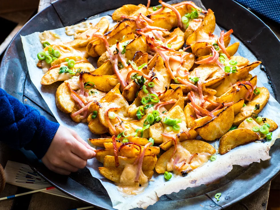 Loaded wedges with smoked cheese sauce and crispy bacon