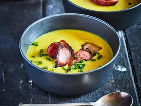 Curried pear and parsnip soup with crispy bacon and chives