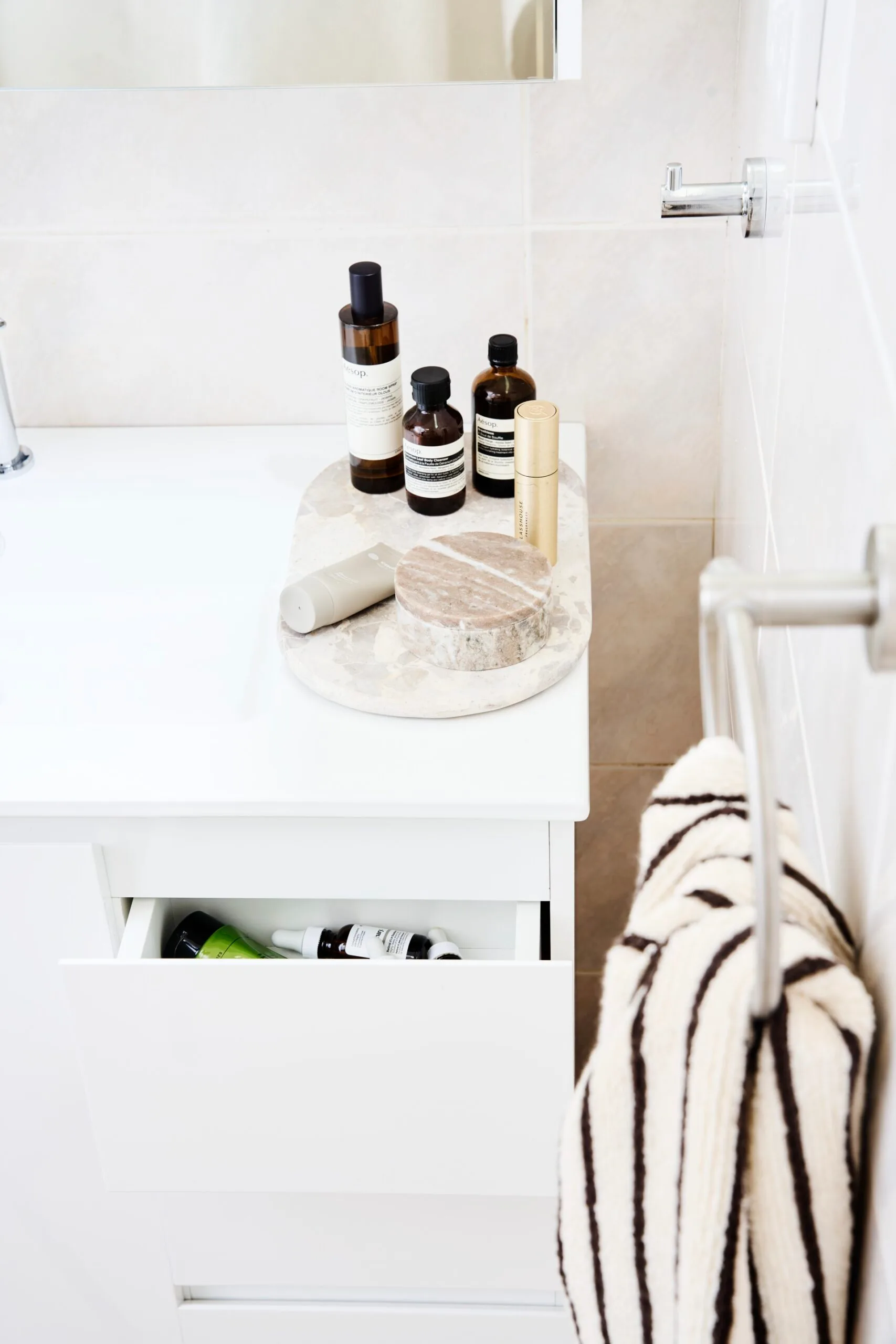 birds eye view of bathroom benchtop with bottles of shampoo