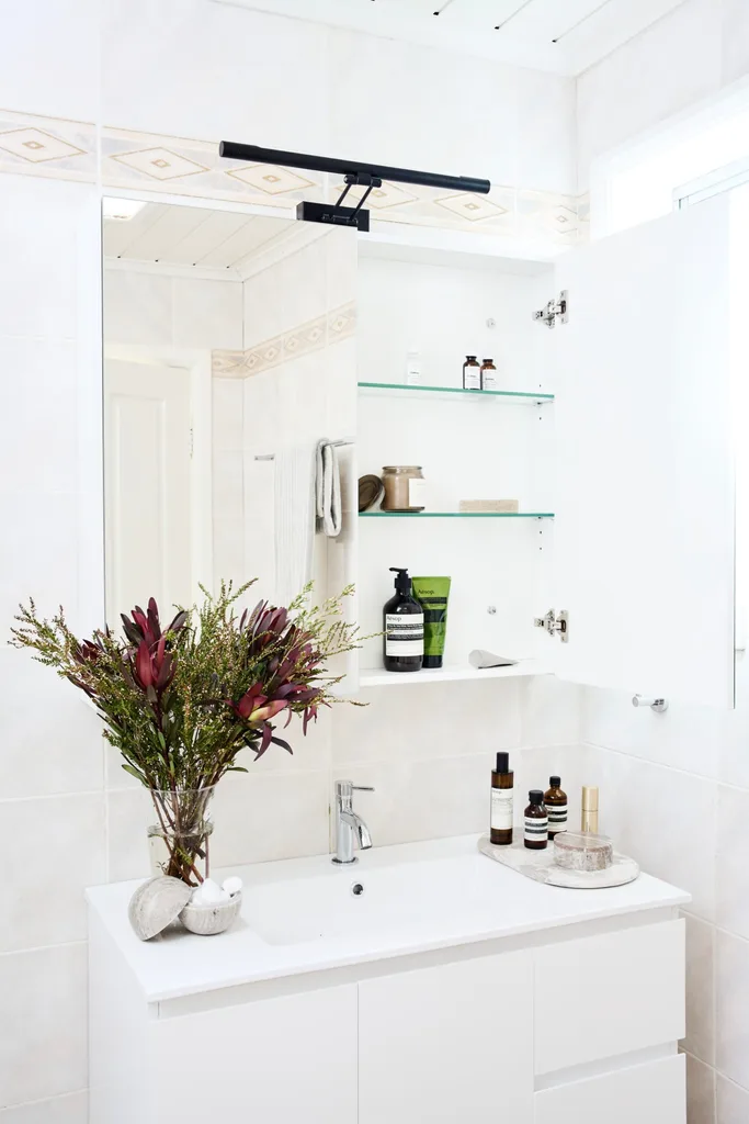 native florals in vase with closer shot of vanity and mirror