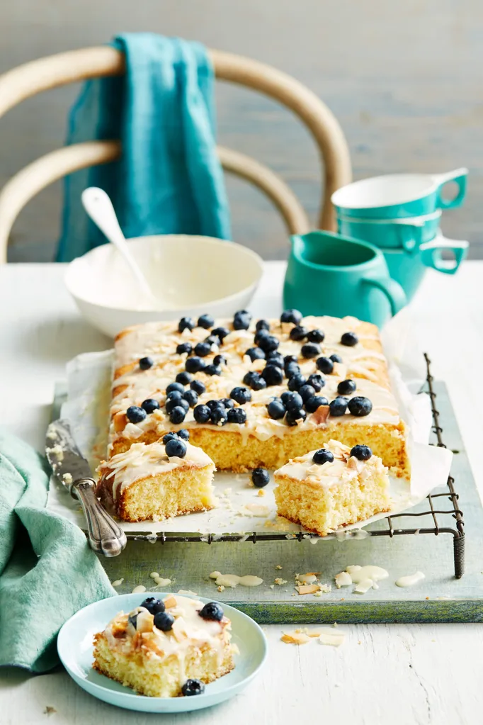 pineapple coconut cake with blueberries on top of running royal icing