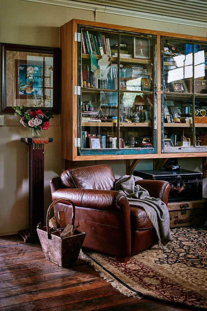 leather couch with shelves behind it