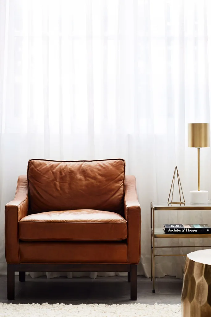 brown leather armchair with side table