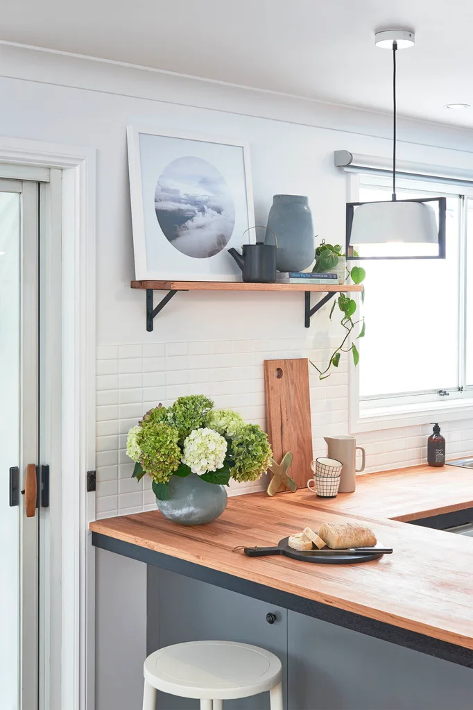 Contemporary renovated kitchen with floating shelf, timber benchtop and blue grey cabinetry.