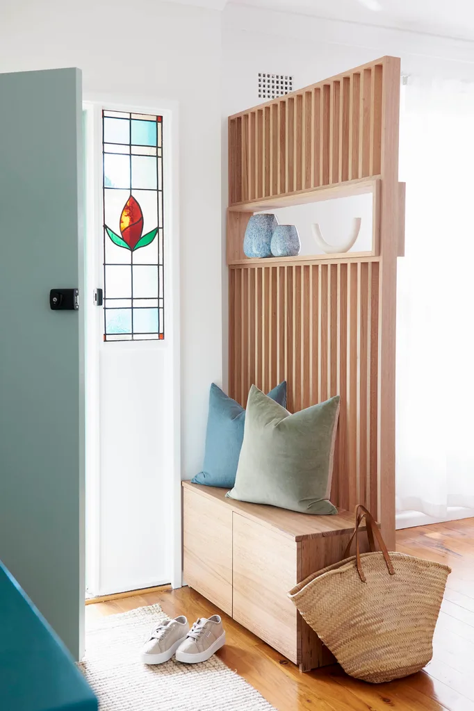 Home entrance with a timber slatted screen and storage bench.