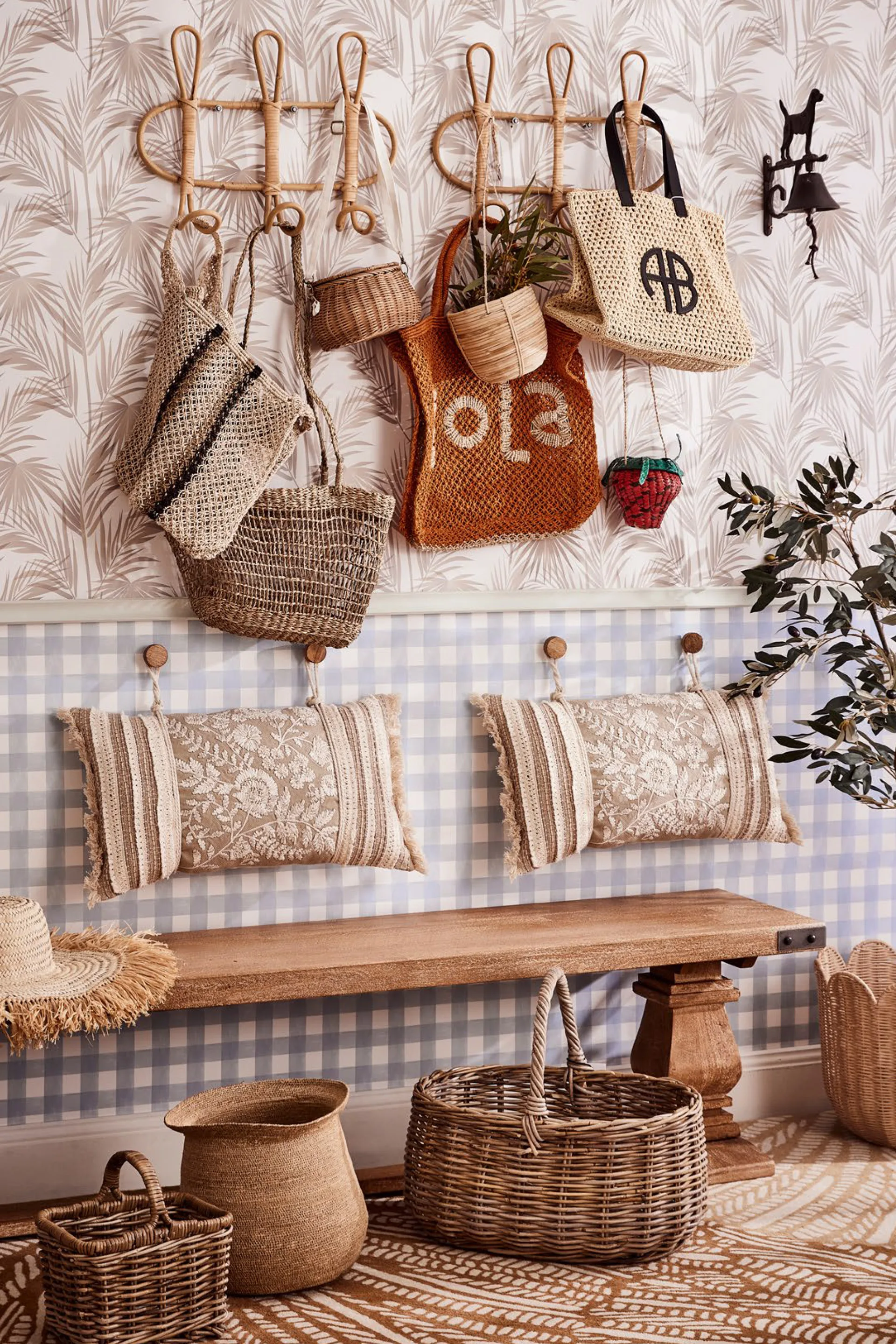entry hall with shopping bags hanging on hooks and a sitting area