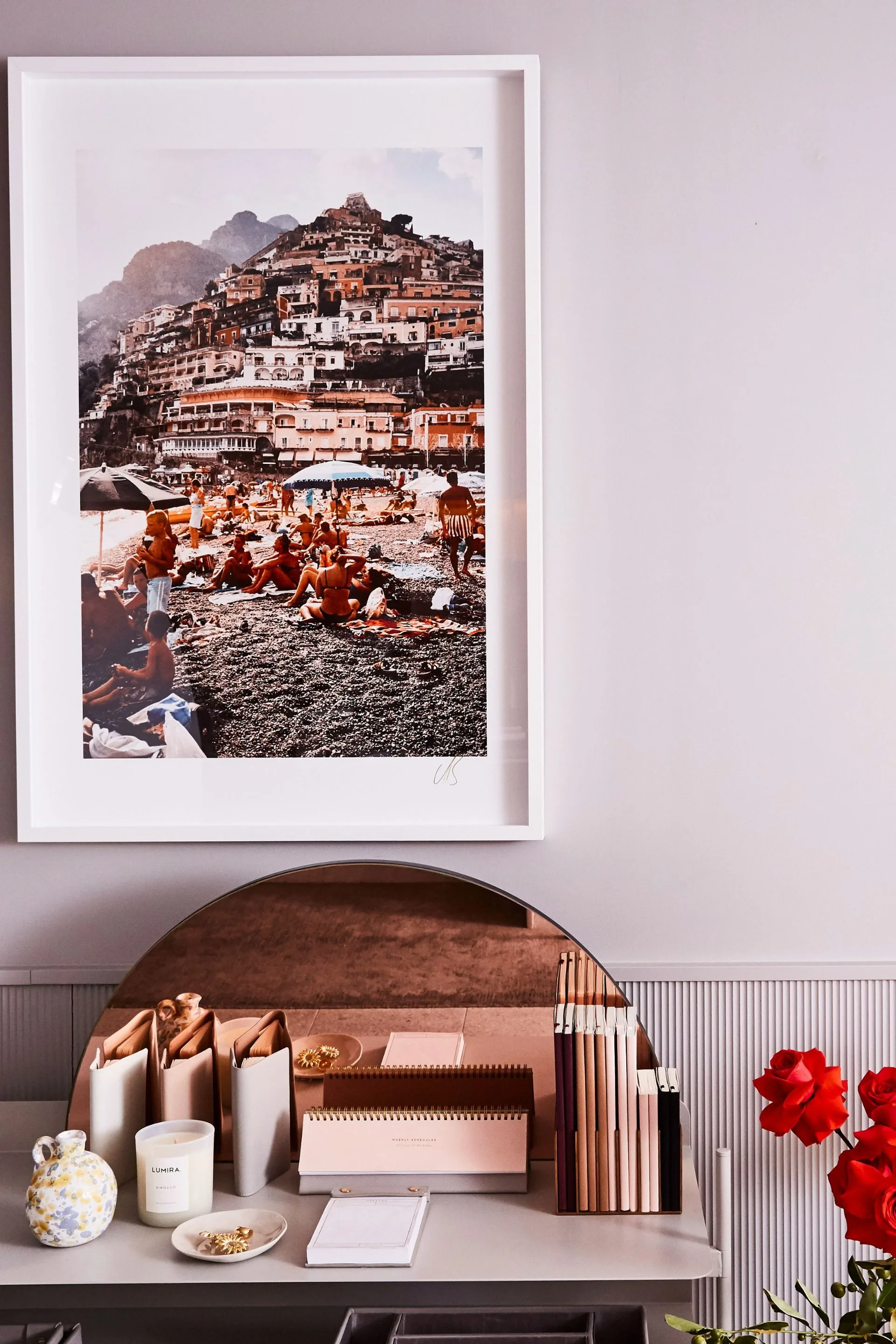 desk with artwork above and organisers on it
