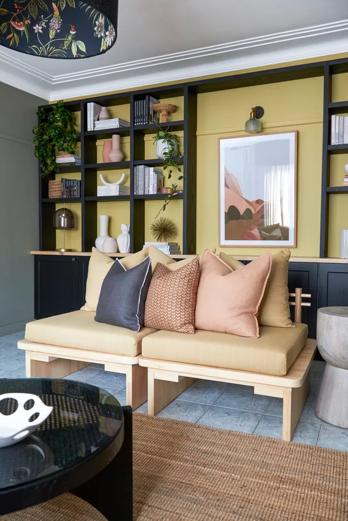 styling living room decor on a decorative wall with library shelving and lots of objects