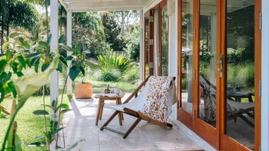 Holiday home verandah with a deck chair and small table