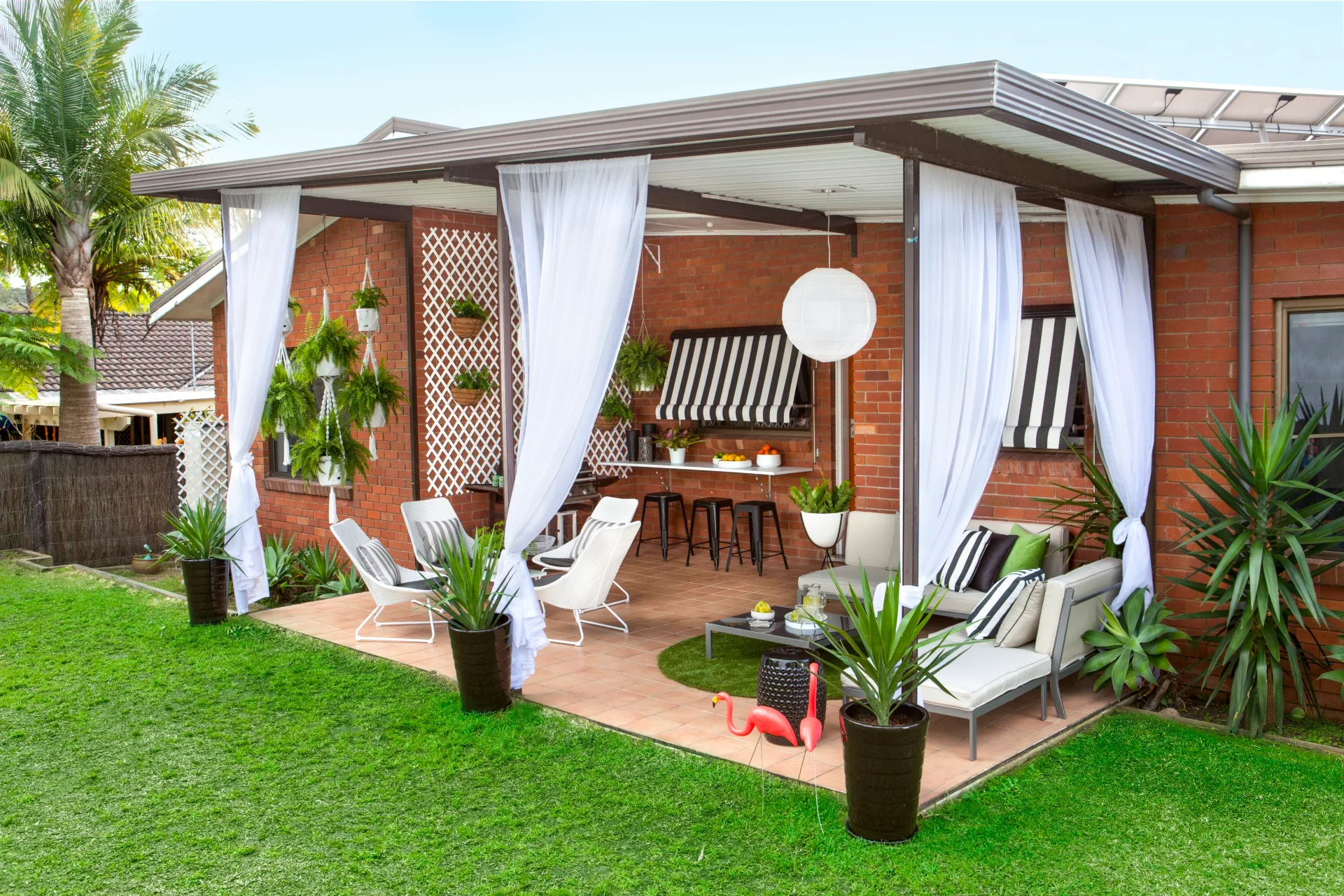 hybrid pergola with curtains and plants dotting the outside