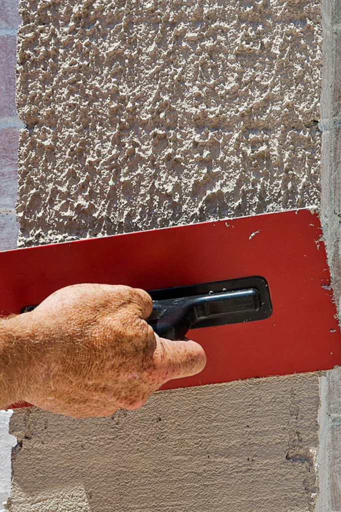 red scraper covering brick wall