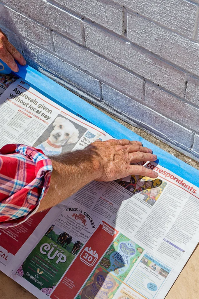 newspaper being taped on floor