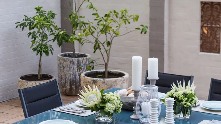 white brick walls in courtyard with table set