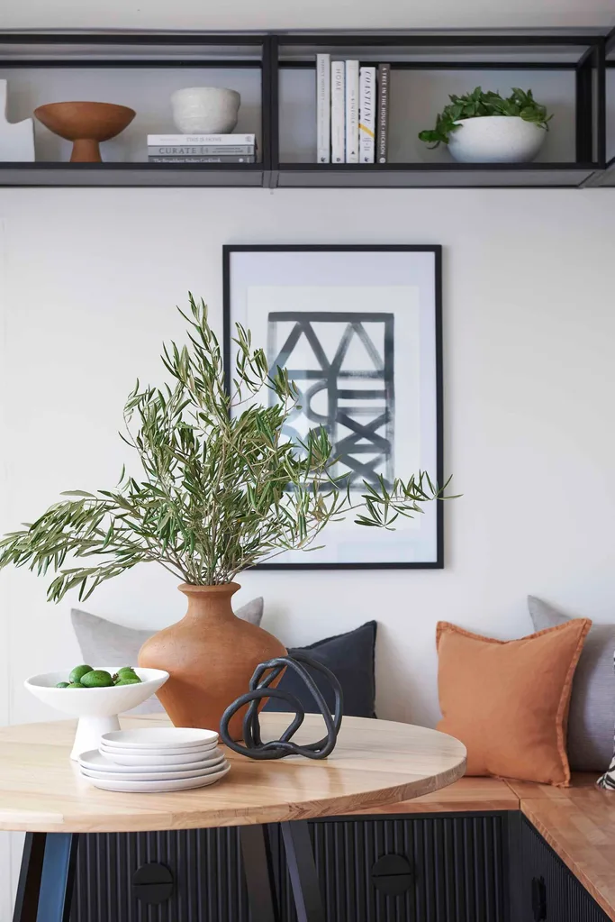 Contemporary modern dining nook with banquette seating and upper shelving