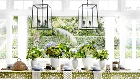 dining table with greenery and light fixtures