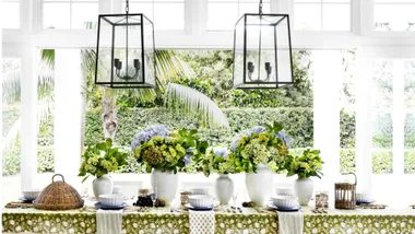 dining table with greenery and light fixtures