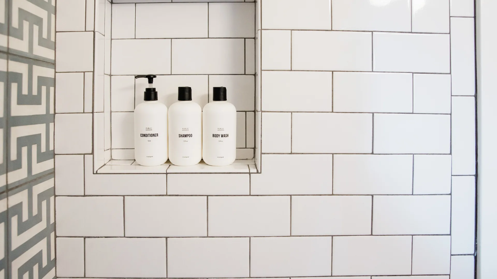 white shower tiles with dirty grout