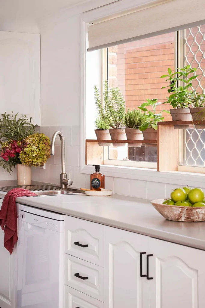 Cosmetically updated country style kitchen with a herb window garden.
